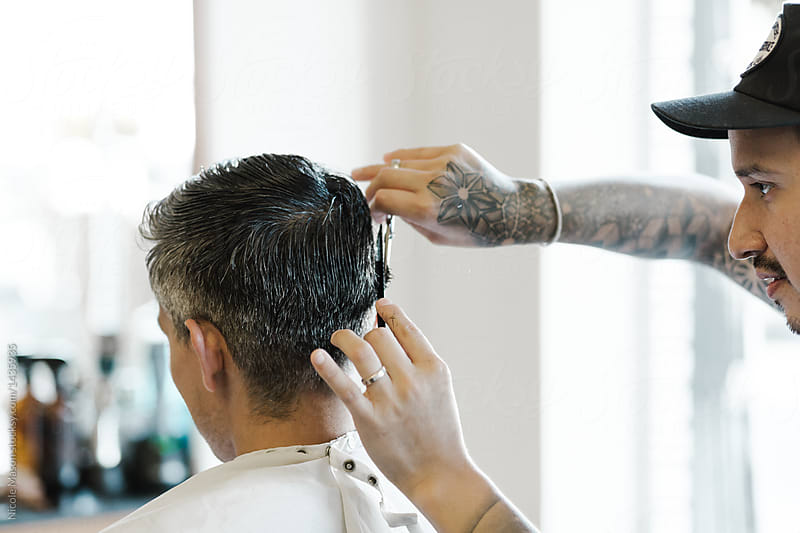 Barber cutting a customer’s hair in a neighborhood shop