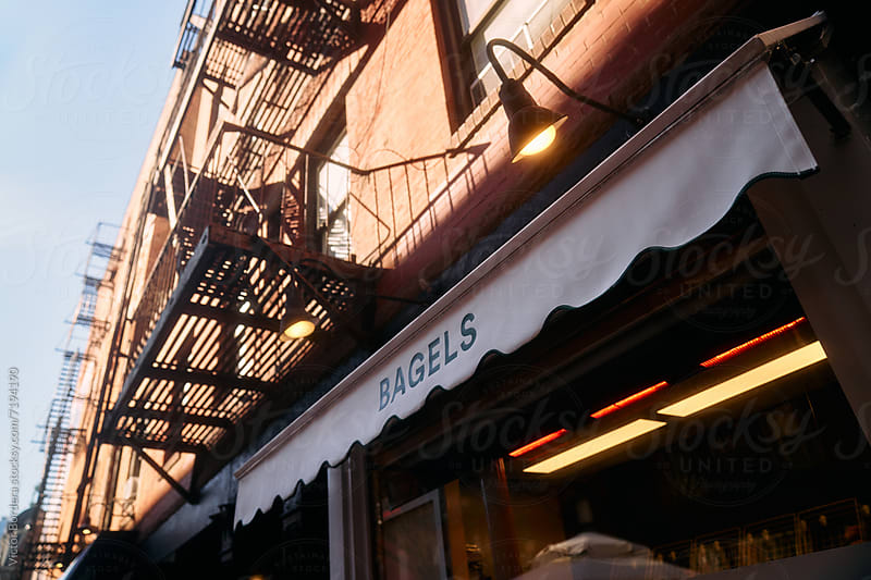 Bagel shop awning beneath fire escapes in New York City